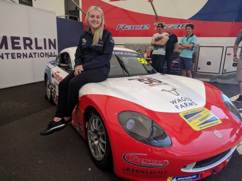 Katie Milner on a race car