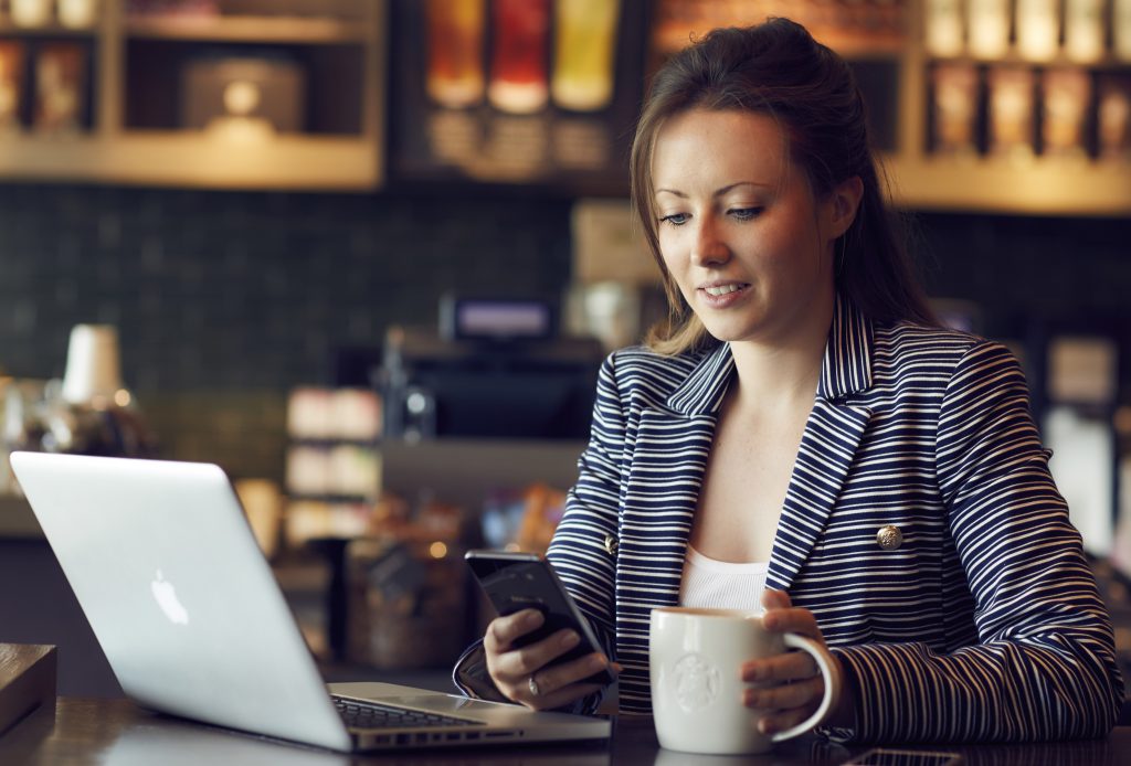 Woman in a coffee shop connected to WiFi